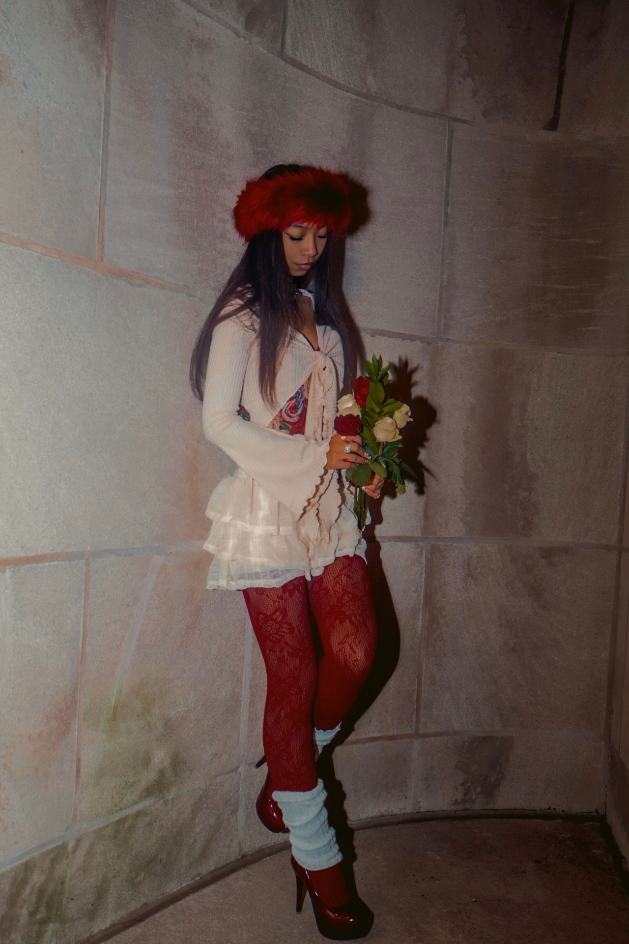 Inaya Malik in red fur and roses — cinematic moment